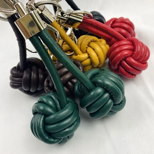 Close-up of handmade leather woven monkey fist knot keychains in various colors