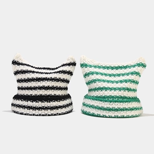 Striped knit beanie with devil ears in black/white and green/white patterns