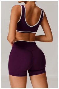 Close-up of cross-back sports set featuring high-waist shorts with white contrast trim