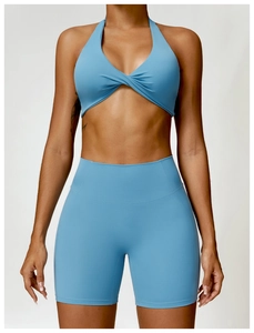 Detail of light blue yoga set featuring a twist front halter top and high waist shorts