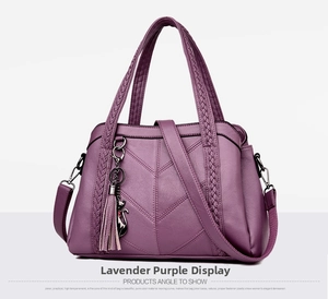 Detail of purple PU leather handbag with V-quilted texture and cat tassel charm