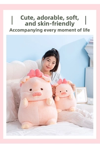 Pink Lulu pig plush toy set with two sizes shown held by a model in a cozy bedroom