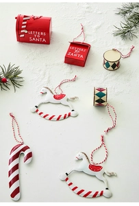 Close-up of metal Christmas ornaments including a Santa mailbox and rocking horse