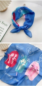 Detail of light blue cotton linen scarf featuring colorful popsicle prints and lettering