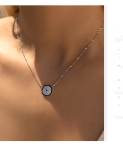 Close-up of S925 silver evil eye pendant necklace with sparkling blue and clear crystals