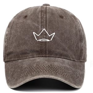 Detailed embroidery of a white crown on a dark coffee washed cotton baseball cap