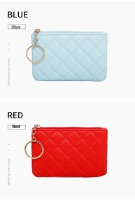 Detail view of quilted PU leather mini coin pouches in blue and red with gold keychains