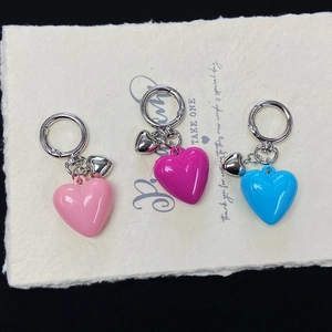 Three-piece colorful resin heart keychains set in pink, rose, and sky blue tones