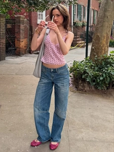 Summer pink polka dot V-neck camisole paired with blue jeans and casual street style