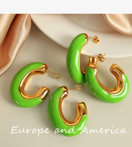 Dettaglio di orecchini a cerchio a C in smalto verde brillante con interno in oro lucido