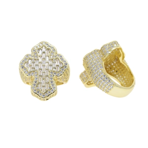 Macro shot of gold-plated cross ring with sparkling pavé-set cubic zirconia stones