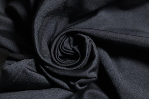 Close-up of premium black ribbed knit fabric with soft texture and elastic sheen
