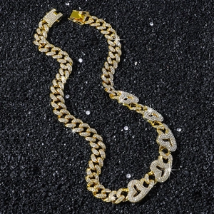 Iced out heart Cuban link chain necklace for men with gold finish and sparkling rhinestones