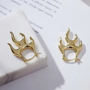 Punk style gold flame huggie hoop earrings with an irregular molten lava metal design