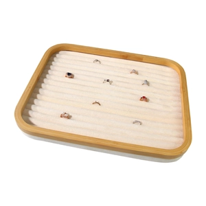 Bamboo jewelry display tray with white velvet slots for ring and earring storage