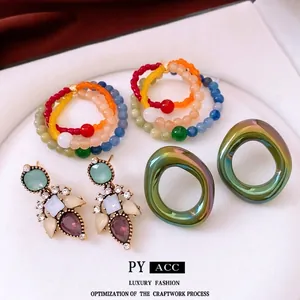 Vintage style jewelry set with beaded rings and crystal drop earrings in vibrant colors