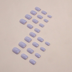 Short square lavender press-on nails set with glossy finish on textured background