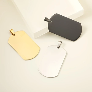 Polished stainless steel dog tag pendants in black, gold and silver on professional display