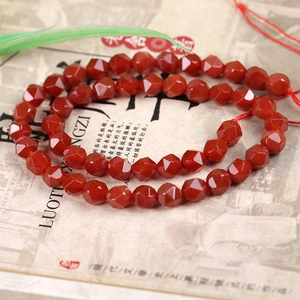 Detail of faceted red agate beads with a polished surface for DIY jewelry making