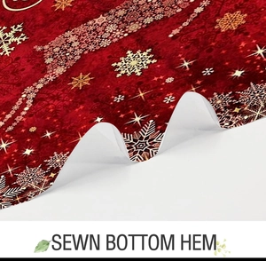 Detailed close-up showing the sewn bottom hem and festive snowflake pattern on Christmas curtain