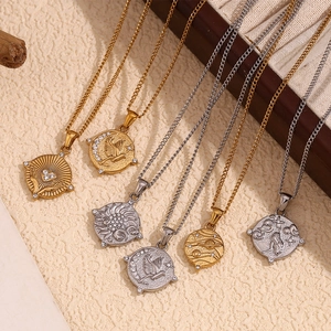 Detail of vintage 18K gold plated tarot card pendants with crystal zodiac relief