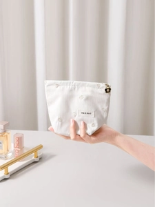 Cute off-white fabric makeup bag with heart embroidery and flower zipper puller