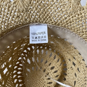 Detail view of the interior sweatband and 100% paper material label of the straw cowboy hat