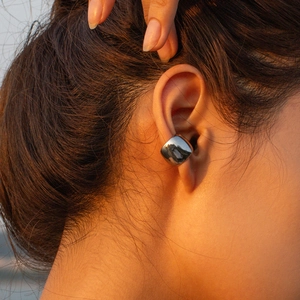 Minimalist silver stainless steel cuff earring with high-polish mirror finish on a model