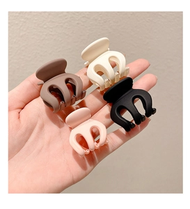Set of four small matte hair claws in brown, cream, black and pink colors