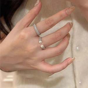 Minimalist pearl and zircon open ring set in silver finish worn by a model