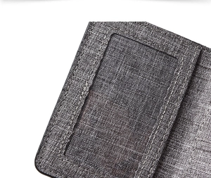 Macro detail of grey canvas wallet showing fine stitching and durable woven texture