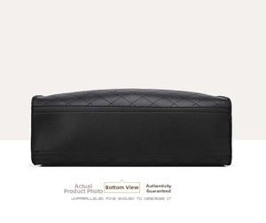 Detail of the black quilted leather bag bottom showing fine stitching and lychee texture
