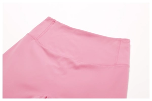 Close-up of high-waist pink yoga pants showing premium stitching and breathable fabric