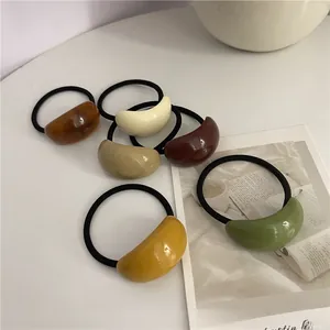 Set of six minimalist resin hair ties in earth tones like amber, cream and avocado green