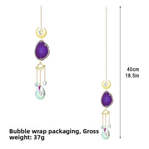 Detail of moon sun catcher with purple agate slice and large crystal teardrop pendant