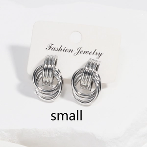 Detail of small silver layered hoop earrings displayed on a white fashion jewelry card