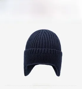 Detailed close-up of dark blue ribbed knit beanie with soft thermal fleece lining