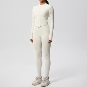 Détail d'un ensemble de yoga blanc cassé avec haut à manches longues zippé et leggings taille haute