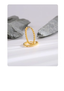 Macro detail of gold S925 sterling silver hoop earrings with a beaded texture design