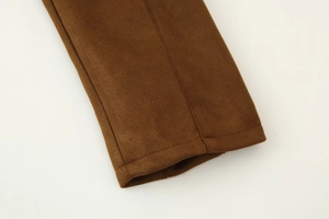 Detailed close-up of brown suede jacket cuff with clean stitching and soft texture