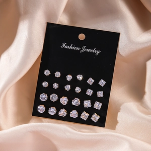 Set of 12 pairs of sparkling gold-tone zircon stud earrings on black display card