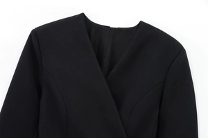 Close-up of elegant V-neckline and shoulder tailoring on a black women blazer