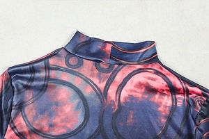 Detail of high collar neckline with abstract print and smooth contrast color fabric