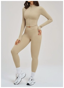 Detail of high-waisted yoga leggings with side pockets and criss-cross waistband design