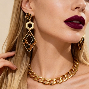Retro leopard print geometric heart earrings worn by a model with a gold chain necklace