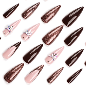 Long stiletto press-on nails with dark brown, rose gold glitter, and rhinestones