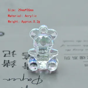 Close-up of a colorful faceted acrylic bear charm with iridescent finish and size details