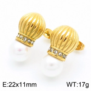 Macro detail of vintage pearl earrings with textured gold metal and small crystals