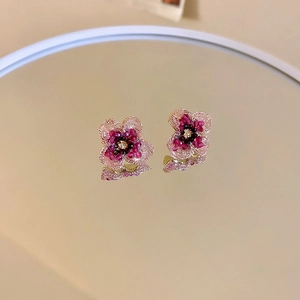 Detailed mirror shot of pink floral beaded earrings with delicate crystal petals