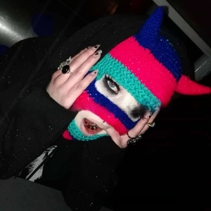 Detail view of handmade crochet balaclava with devil horns and colorful stripes